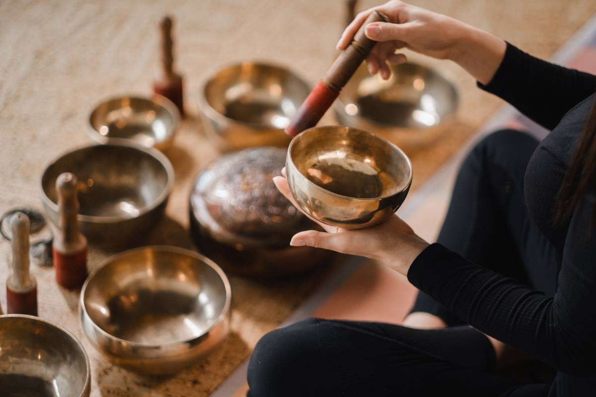 A person using a singing bowl for sound therapy