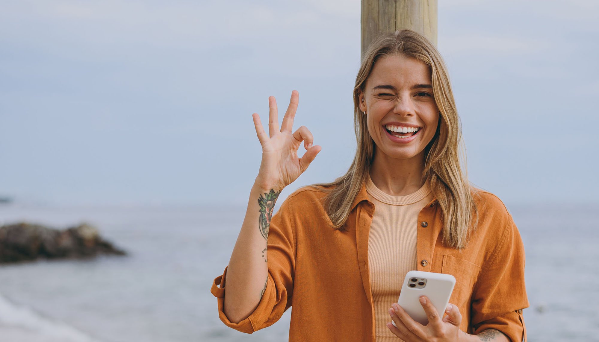 woman at the beach winking