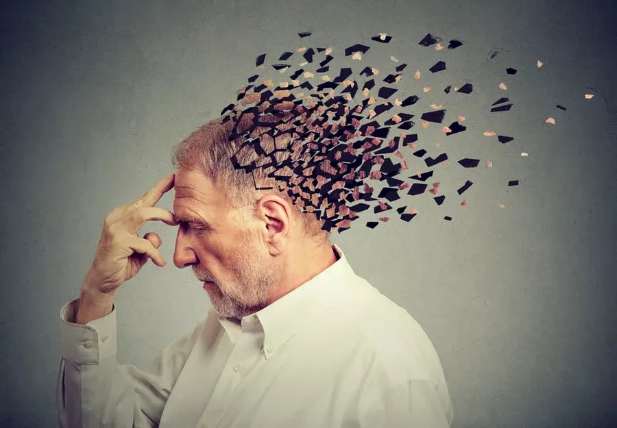 A man touching his head with a graphic symbolizing memory loss