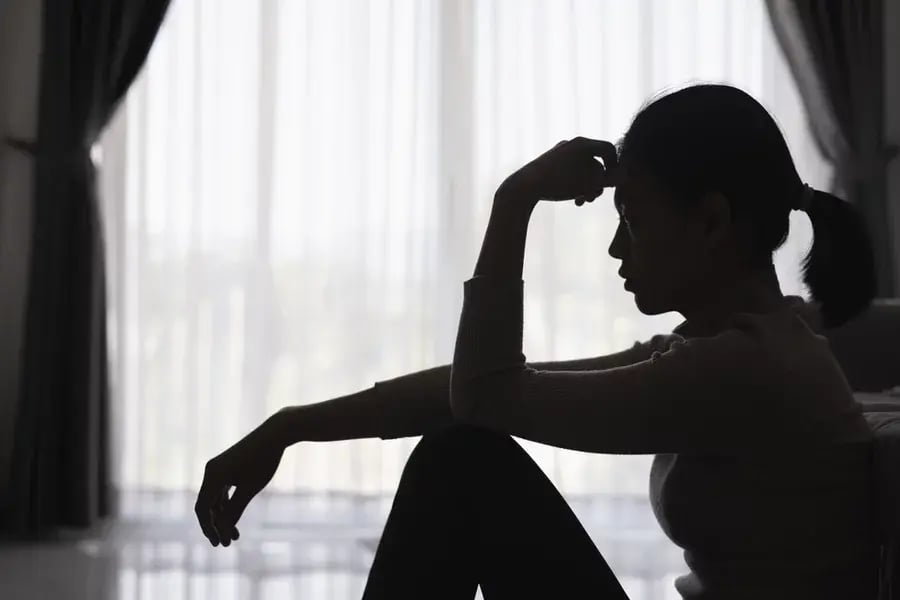 A silhouette of a person suffering from depression
