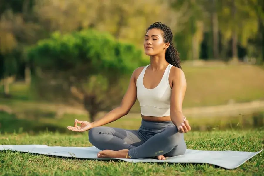A woman meditating outside